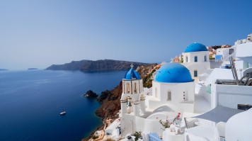 Visit these white buildings with blue roofs during two weeks in Greece.