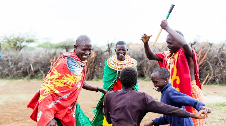 A Maasai family dancing during a festivity.