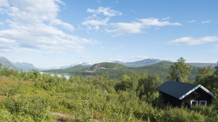 A summer cabin amidst greenery in Kungsleden, King's Hiking trail. A summer cabin amidst greenery in Kungsleden, King's Hiking trail.