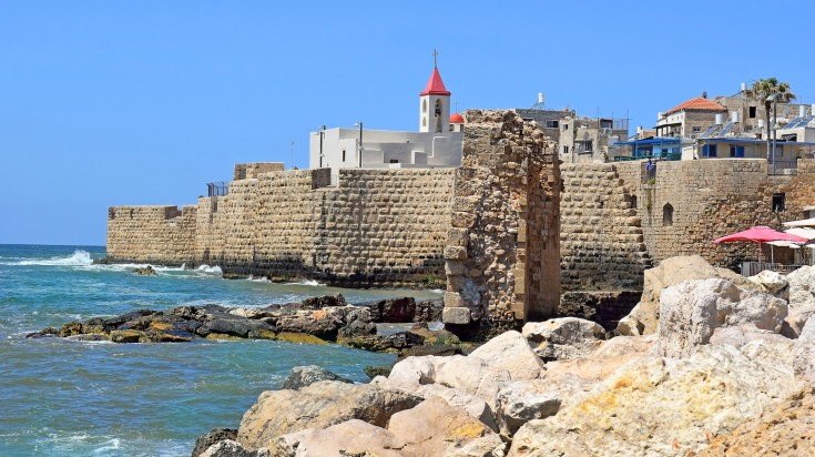 View of the fortress walls and St. John's church in the old city of Acre during a clear day. View of the fortress walls and St. John's church in the old city of Acre.