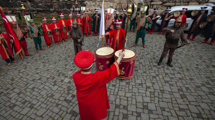 Turkish traditional music band  in red outfit celebrating a festival.