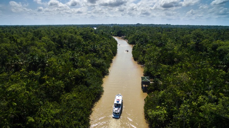 Aerial view of Amazon Rainforest with a boat in Peru. Aerial view of Amazon Rainforest with a boat on a cloudy day