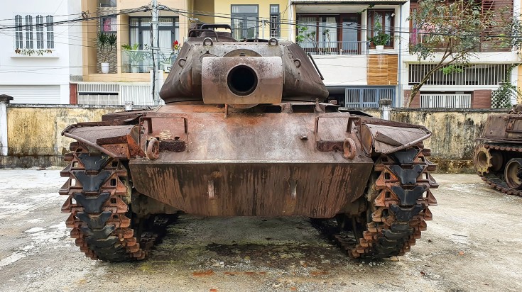 An old rusty tank displayed in a Viatnamese museum.