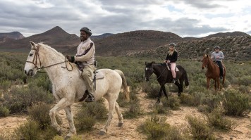 Tourists participating in horseback safaris in Aquila Private Game Reserve.