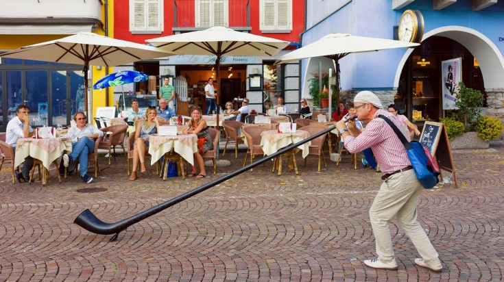 Watch street performers entertain people in Switzerland in June.