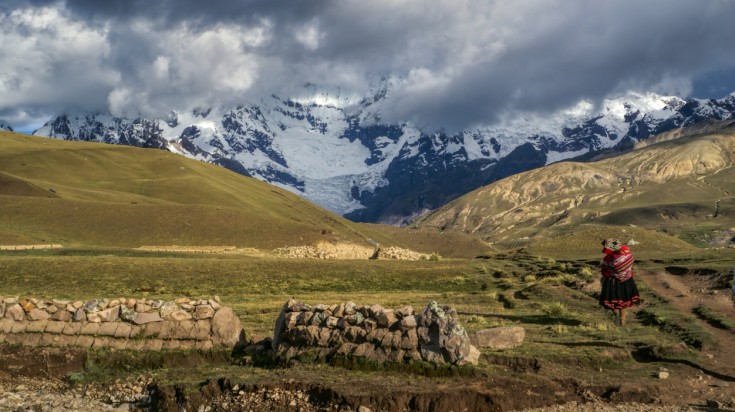 An indigenous woman walking on the Ausangate trekking trail