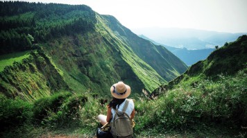 A woman traveler admiring the beauty of nature in the Azores.