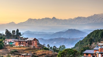 A view of settlements in Bandipur with foggy mountains in the background.