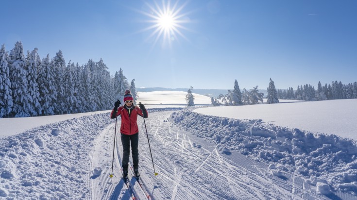 A woman skiing in the snow at Allgau alps in Bavaria in Germany.