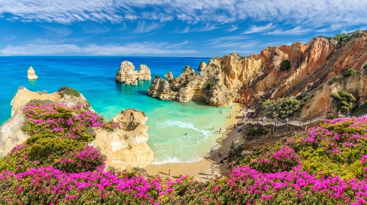See the stunning landscape at Praia do Camilo in Algarve during a 21-day trip of Portugal.