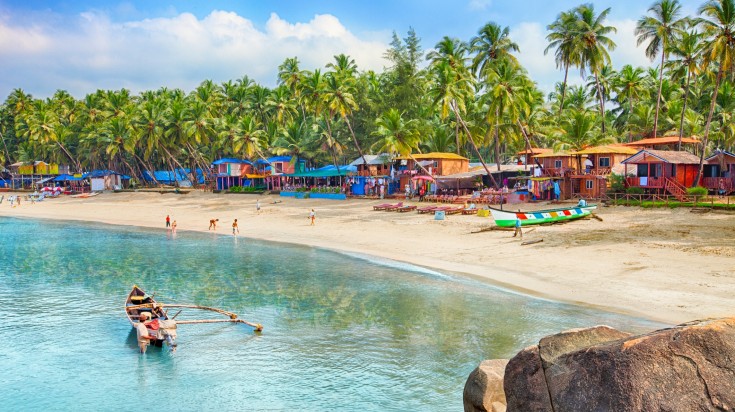 Palolem beach in Goa with colorful houses. 