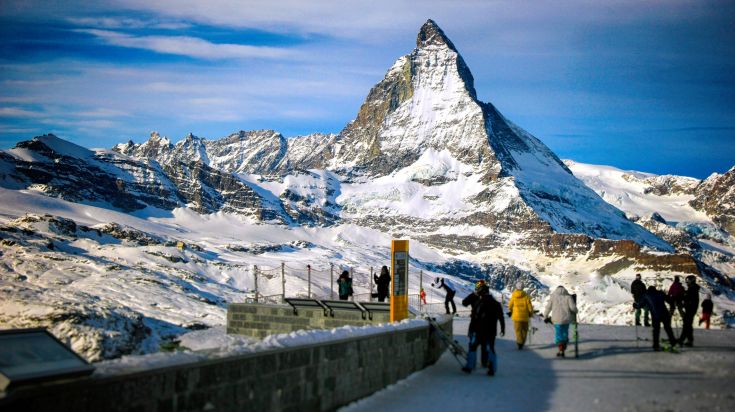 Picturesque view of the Zermatt in the Swiss Alps with crowds.