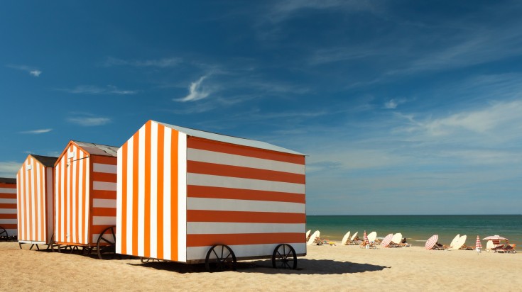 Beach cabins on a sunny day in De Panne.