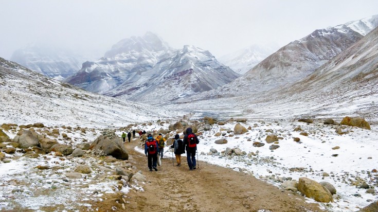 The sacred Mount Kailash, often referred to as the spiritual centre of the world, is not just a holy site in Buddhism, but also, in Hinduism, Bon and Jainism Tourists trekking around the base of a Mountain