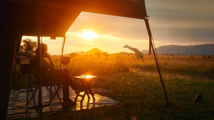 Woman rest in a luxury tent in her safari tour in Serengeti National Park