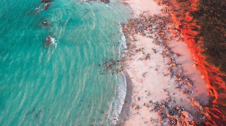 Gantheaume Point lit red at sunset in Broome.