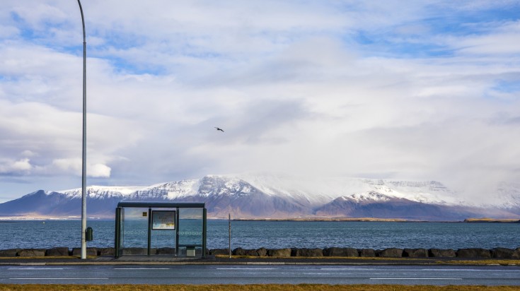 A bus stand with a scenic view behind it in Reykjavik.