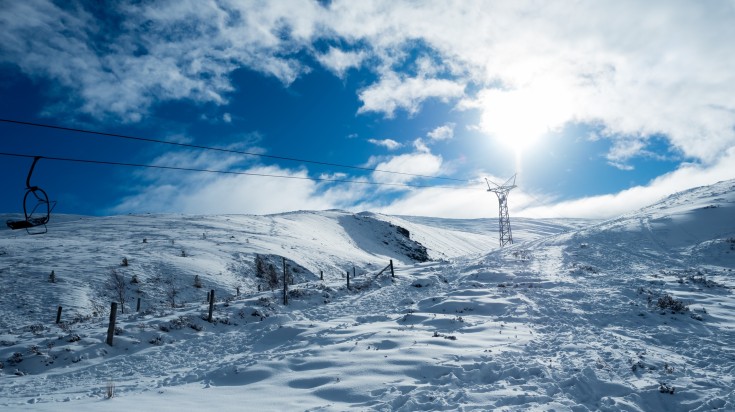 A ski lift in the Scottish Highlands during winter.