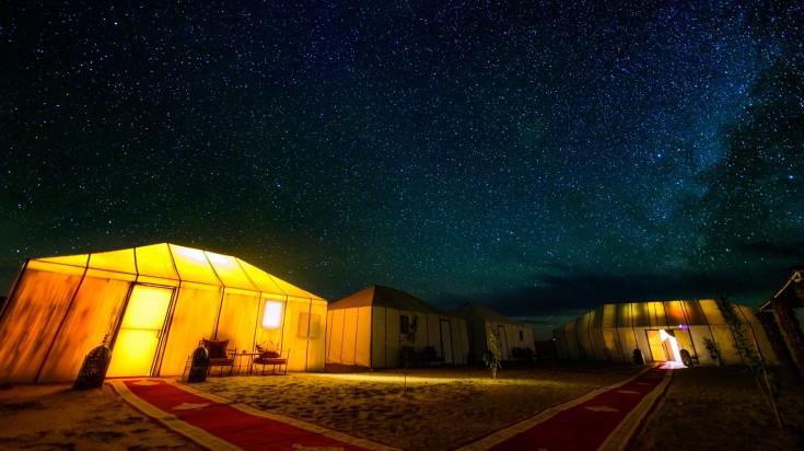 Camping under the stars at Sahara Desert at night.