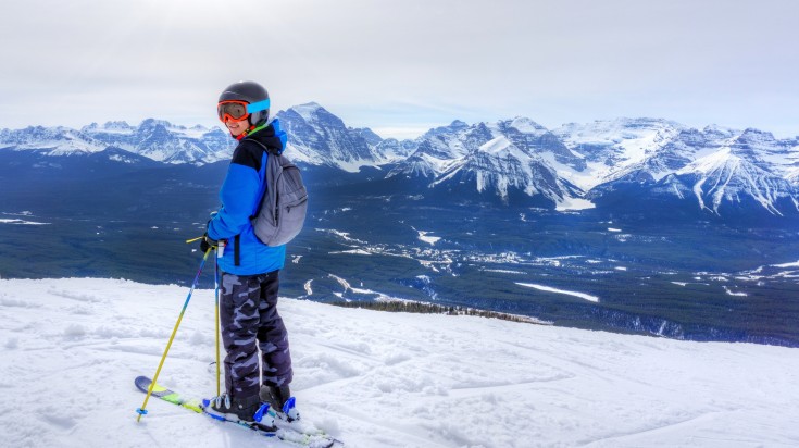 A young skier posing in Lake Louise in Canada in November.