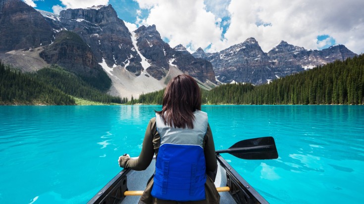 A tourist canoeing in Moraine Lake in Banff National Park in Canada in July.