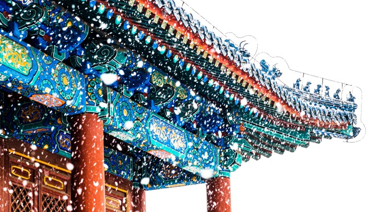 A traditional roof in China in January during snowfall.