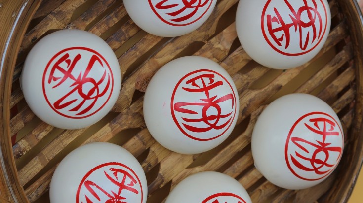 Sweet white buns in a wooden case in China in May.