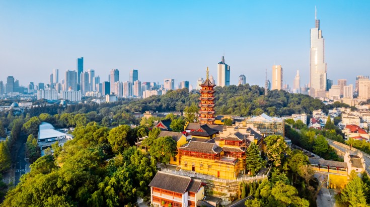 Aerial view of Jiming Temple and Zifeng building in Nanjing on a sunny day.