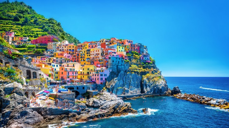 Hiking in Italy via Cinque terre trail—A famously scenic trek.