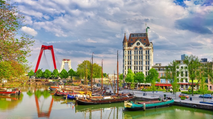 Rotterdam Harbor with sailboats and the cityscapes on the background.