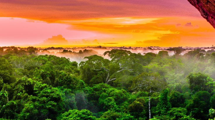 sunset over rainforest by Leticia in Colombia in July