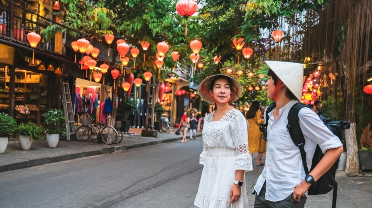 Couple exploring Hoi An on foot.