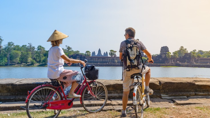Couple marveling at Angkor temple on their 7-day bicycle tour of Cambodia. Couple marvelling at Angkor temple on their 7-day bicycle tour of Cambodia.