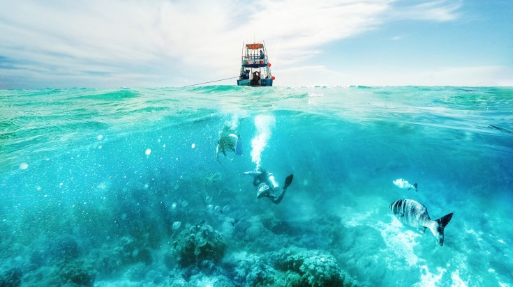 Fishing boat and snorkelers in Cozumel, Mexico.