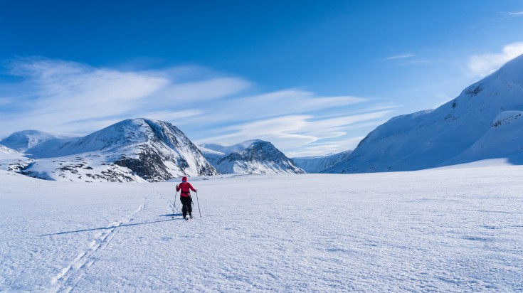 A woman partaking in cross-country skiing in Swedish Lapland.