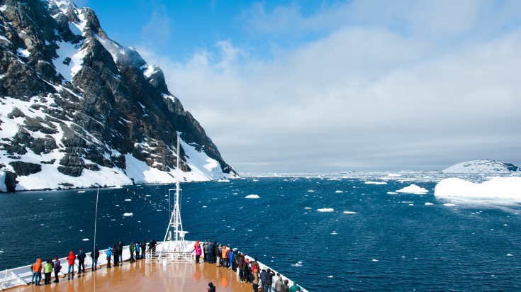 Cruise ship with passengers traveling from Ushuaia to Antarctica passing the mountains and glaciers.