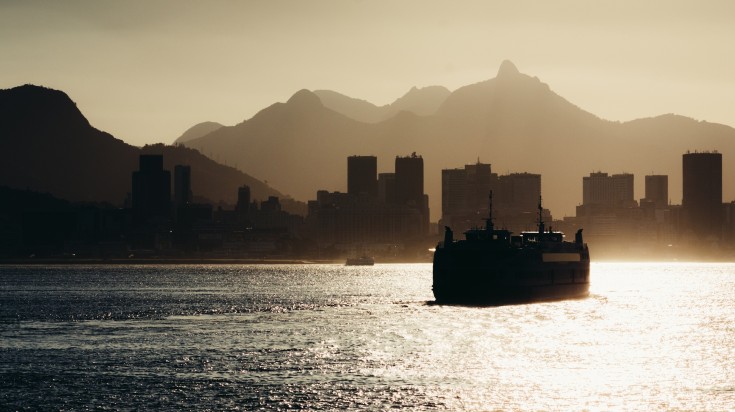 A cruise with Rio de Janeiro in the background at sunset.
