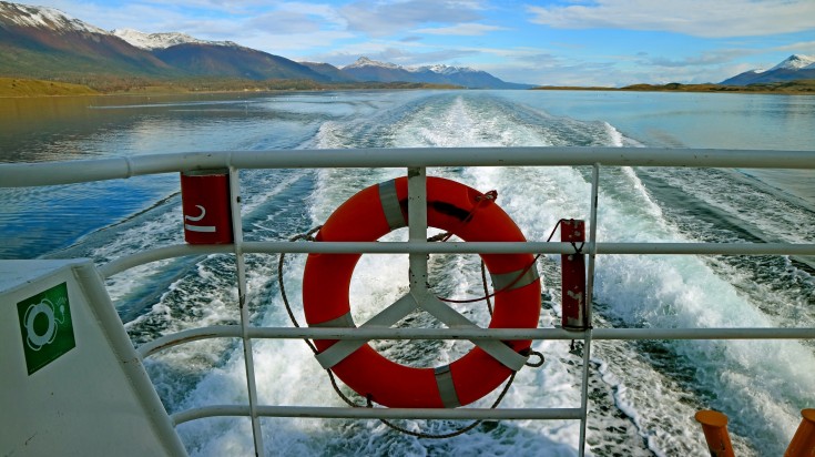 Powerful sea foam behind the stern of a speeding cruise liner , Patagonia.