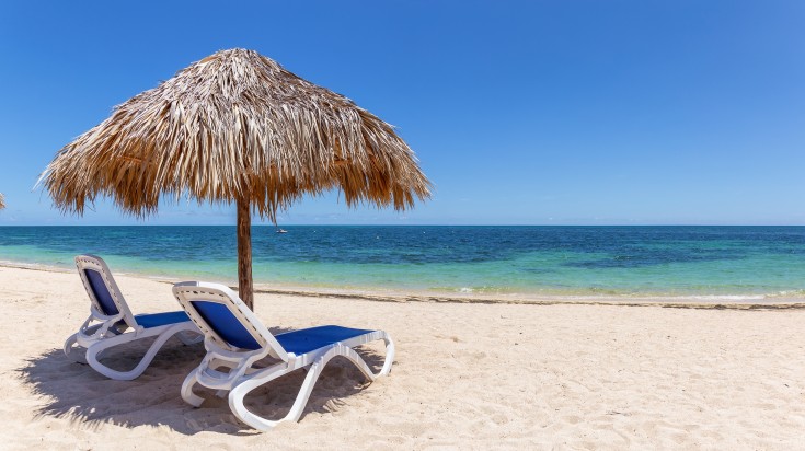 Deckchairs and shade on Ancon beach in Cuba.