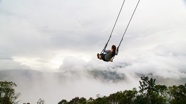 Play on a swing like this lady in Banos.