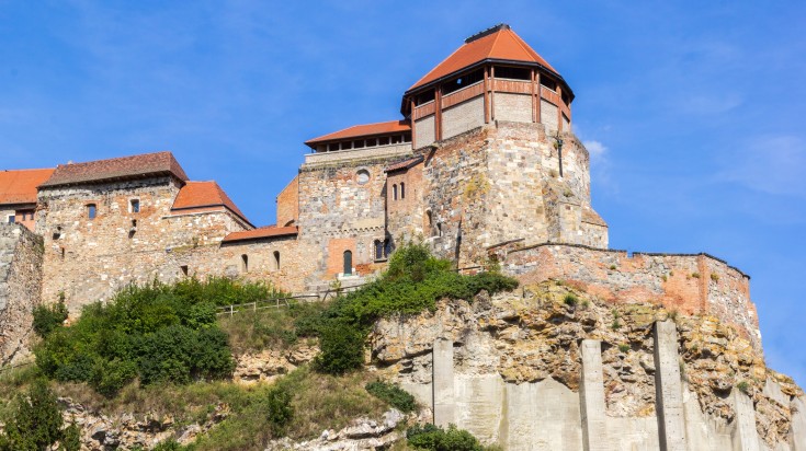 Esztergom Castle perched on top of a hill on a sunny day.