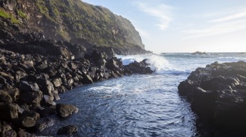 Located off the western shore of Sao Miguel, Ferraria hot spring works as a hot tub during low tide. A thermal pool meets the ocean at a rocky coast