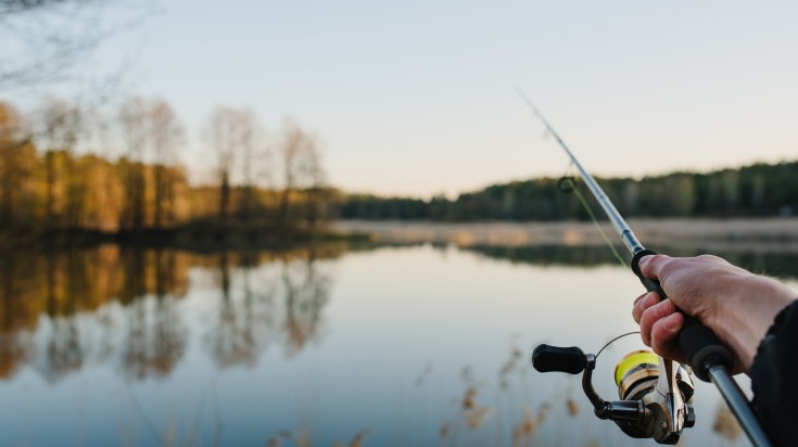 Fisherman fishing on a Finnish lake during summer.