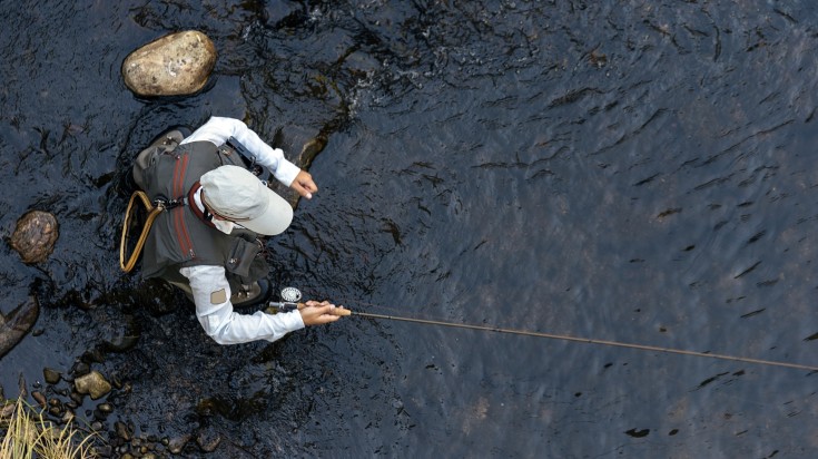 A view from top of a man fly fishing in Bariloche.