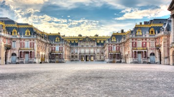 See the glorious architecture on a private tour of Versailles. See Versailles palace under a cloudy sky on your tour.