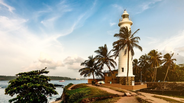 White lighthouse in fort Galle during sunset in Sri Lanka.
