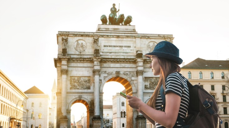 A tourists passes by Triumphal Arch through Munich in Germany in May.