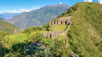 A view of the ruins of the Incan site in Peru atop a hill.