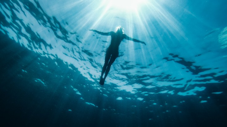 Underwater photo of woman floating in the sea