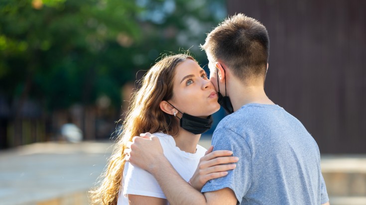 Two friends greeting each other with a kiss in Argentina.